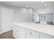 Open-concept kitchen with island, white cabinets, and easy access to the dining area through double doors at 2045 Pin Oak Pl, Cramerton, NC 28032