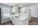 Contemporary kitchen with white cabinetry, a stainless steel sink, and sleek countertops at 2045 Pin Oak Pl, Cramerton, NC 28032