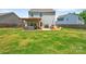 Spacious backyard with patio, lush green lawn, play structures, ideal for Gathering fun and outdoor gatherings at 210 Clove Hitch Dr, Salisbury, NC 28677