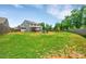 Expansive backyard with lush lawn, fire pit, play set, and patio, perfect for outdoor enjoyment and activities at 210 Clove Hitch Dr, Salisbury, NC 28677