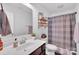 Bright bathroom featuring a decorative shelf, updated vanity, toilet, and shower with patterned curtain at 210 Clove Hitch Dr, Salisbury, NC 28677