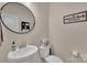 Cozy half-bath featuring a pedestal sink, modern fixtures, and decorative wall art at 210 Clove Hitch Dr, Salisbury, NC 28677