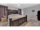 A bedroom suite featuring a large bed with headboard and dark furnishings and decor at 210 Clove Hitch Dr, Salisbury, NC 28677