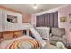 Charming bedroom featuring a bunk bed with slide, rainbow decor and a cozy gray chair at 210 Clove Hitch Dr, Salisbury, NC 28677
