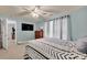 A serene bedroom boasts modern decor, a ceiling fan, TV and calming natural light at 210 Clove Hitch Dr, Salisbury, NC 28677