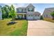 Charming two-story home with a well-manicured lawn and a two-car garage at 210 Clove Hitch Dr, Salisbury, NC 28677