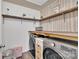 Well-organized laundry room with wooden shelves, modern washer and dryer units at 210 Clove Hitch Dr, Salisbury, NC 28677