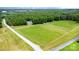 Expansive aerial view of the property featuring a house, gardens, surrounding greenery, and an access road at 2159 Quiet Cove Ln, Stanfield, NC 28163