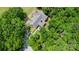 Aerial view of a lovely property nestled among lush greenery and mature trees at 2159 Quiet Cove Ln, Stanfield, NC 28163