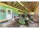 Interior view of the barn showcasing a tractor, green siding, and an access door at 2159 Quiet Cove Ln, Stanfield, NC 28163