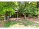 Outdoor barn area with visible storage for farm equipment and supplies, surrounded by trees at 2159 Quiet Cove Ln, Stanfield, NC 28163