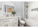 Bright bathroom with a marble tiled shower and a modern white vanity at 2159 Quiet Cove Ln, Stanfield, NC 28163