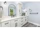 Elegant bathroom with dual vanities, marble floors, and modern fixtures at 2159 Quiet Cove Ln, Stanfield, NC 28163