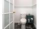 This half bathroom features wainscoting, marble floors, and a dark blue side table at 2159 Quiet Cove Ln, Stanfield, NC 28163