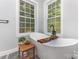 Serene bathroom with a freestanding tub, natural light, and stylish accents at 2159 Quiet Cove Ln, Stanfield, NC 28163