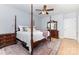 Comfortable bedroom with a four-poster bed, hardwood floors, and stylish furnishings at 2159 Quiet Cove Ln, Stanfield, NC 28163
