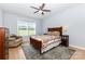 Cozy bedroom featuring light blue walls, hardwood floors, and a patterned bedspread at 2159 Quiet Cove Ln, Stanfield, NC 28163