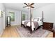 Bright bedroom with a four-poster bed, hardwood floors, and ample natural light at 2159 Quiet Cove Ln, Stanfield, NC 28163
