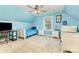 This bright bedroom features blue walls, carpeted floors, and two twin beds at 2159 Quiet Cove Ln, Stanfield, NC 28163