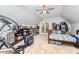 Cozy bedroom features a ceiling fan, warm carpet, exercise machine, shelving, and a closet at 2159 Quiet Cove Ln, Stanfield, NC 28163