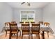 Bright dining room with hardwood floors and a large window overlooking the green yard at 2159 Quiet Cove Ln, Stanfield, NC 28163