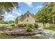 Inviting home featuring well-maintained landscaping, stone pathways and lush greenery at 2159 Quiet Cove Ln, Stanfield, NC 28163