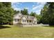 Charming two-story home with a well-maintained lawn and beautiful landscaping at 2159 Quiet Cove Ln, Stanfield, NC 28163