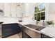 Contemporary kitchen highlighting a stainless steel farmhouse sink and elegant countertops at 2159 Quiet Cove Ln, Stanfield, NC 28163