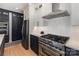 Well-appointed kitchen with stainless steel appliances, ample cabinetry, and hardwood floors at 2159 Quiet Cove Ln, Stanfield, NC 28163