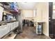 Well-equipped laundry room featuring shelving, appliances, a table and exterior door at 2159 Quiet Cove Ln, Stanfield, NC 28163