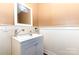 A neat powder room featuring wainscoting, neutral wall color and modern fixtures at 2159 Quiet Cove Ln, Stanfield, NC 28163
