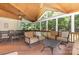 Inviting screened porch with dining and lounge areas, perfect for outdoor relaxation at 2159 Quiet Cove Ln, Stanfield, NC 28163