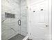 Modern shower with marble tile and sleek glass door at 2159 Quiet Cove Ln, Stanfield, NC 28163