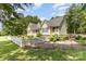 Bright home showcasing well-maintained landscaping and a quaint white picket fence at 2159 Quiet Cove Ln, Stanfield, NC 28163