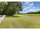 Lush green yard with a charming white fence, offering a serene outdoor space at 2159 Quiet Cove Ln, Stanfield, NC 28163