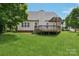 Spacious backyard with a wooden deck and lush green lawn at 2321 Oberwood Dr, Charlotte, NC 28270
