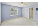 Light-filled bedroom featuring blue walls, neutral carpet, and a view of the ensuite bath at 2321 Oberwood Dr, Charlotte, NC 28270