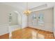 Charming dining room with hardwood floors, chandelier, and views of adjoining rooms at 2321 Oberwood Dr, Charlotte, NC 28270