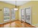 Sunlit dining room with plantation shutters and french doors to the patio at 2321 Oberwood Dr, Charlotte, NC 28270