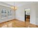 Elegant dining room with hardwood floors, chandelier, and classic wainscoting detail at 2321 Oberwood Dr, Charlotte, NC 28270