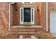Close-up of the elegant front door with brick surround, enhancing the home's curb appeal at 2321 Oberwood Dr, Charlotte, NC 28270