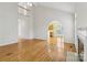 Bright, open-concept living room featuring hardwood floors and an arched entry to kitchen at 2321 Oberwood Dr, Charlotte, NC 28270