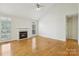 Comfortable living room with a fireplace, hardwood floors, and bright natural light at 2321 Oberwood Dr, Charlotte, NC 28270