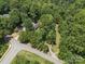 Aerial view of the property with mature trees and a road running nearby at 2345 Stallings Rd, Matthews, NC 28104