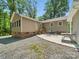 Back of house with patio and metal outdoor dining table and chairs, gravel yard at 2345 Stallings Rd, Matthews, NC 28104