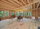 Unfinished bonus room featuring exposed wood walls, beams and joists, hardwood flooring, and several windows at 2345 Stallings Rd, Matthews, NC 28104
