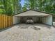 The metal carport features a gravel driveway and a gray off-road vehicle at 2345 Stallings Rd, Matthews, NC 28104