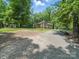 A serene backyard surrounded by lush trees, offering a private and peaceful retreat from the city at 2345 Stallings Rd, Matthews, NC 28104