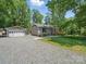 Charming home with a detached garage and well-manicured lawn, nestled in a peaceful, wooded setting at 2345 Stallings Rd, Matthews, NC 28104