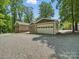 View of detached garage with large door, offering secure parking and storage at 2345 Stallings Rd, Matthews, NC 28104